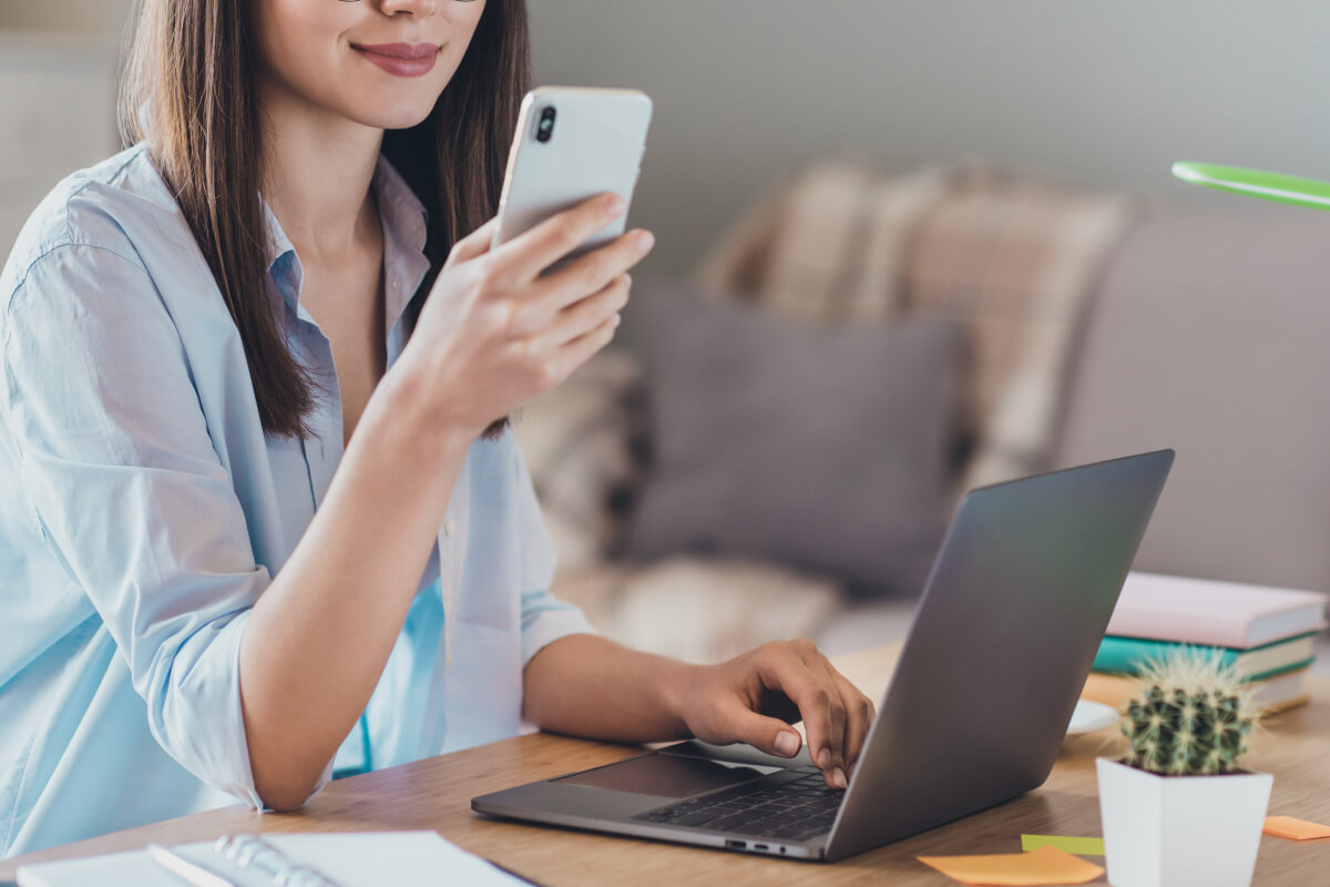 携帯とPCを触る女性